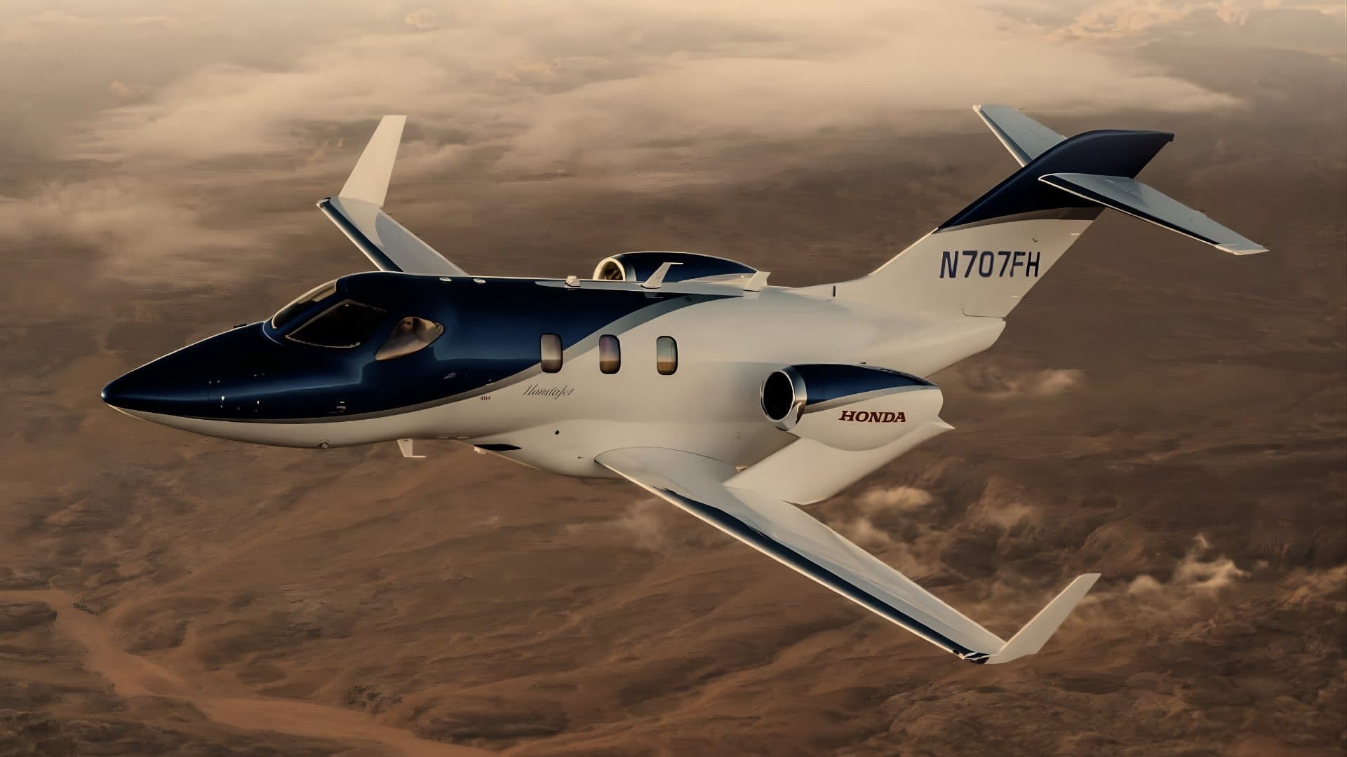 Private jet in flight above the clouds